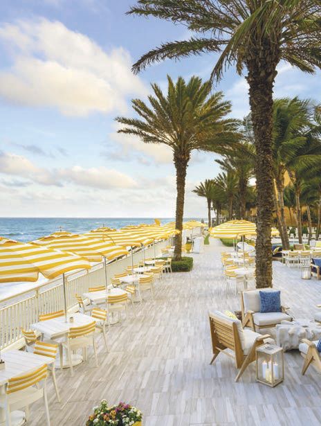Tables line the waterfront deck overlooking the Atlantic Ocean PHOTO COURTESY OF EAU PALM BEACH RESORT & SPA